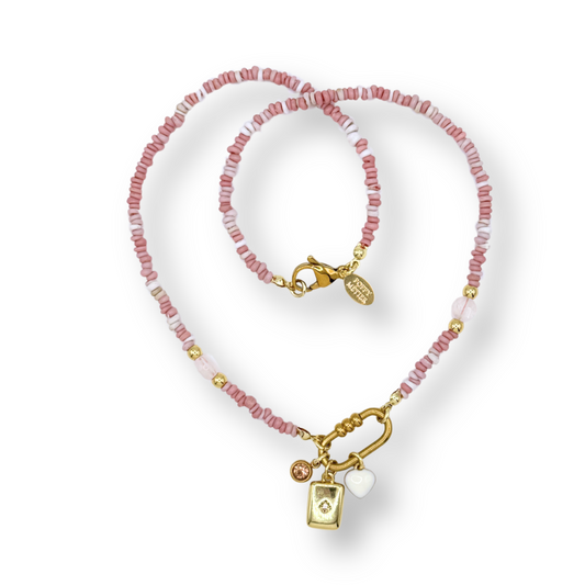 beaded light pink necklace with gold accents on a white background