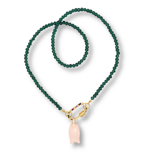 Green beaded necklace with a gold clasp and pink pendant on a white background