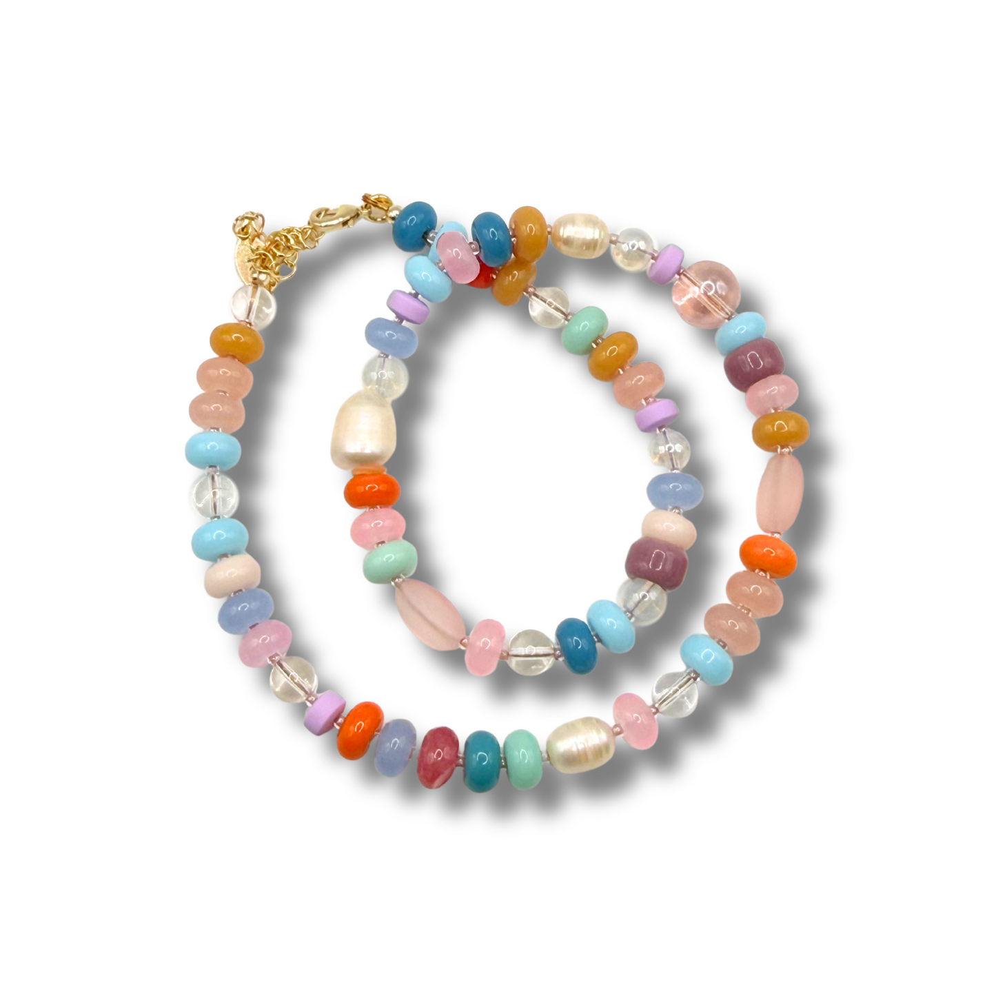 A necklace featuring a mix of pastel pink, blue, orange, green, purple, and clear beads, finished with a gold clasp, shown on a white background.