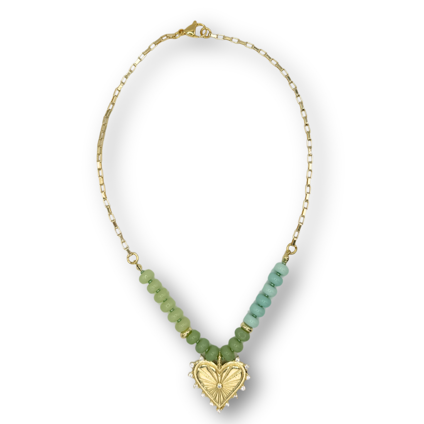 Necklace with green beads and a gold heart pendant on a white background