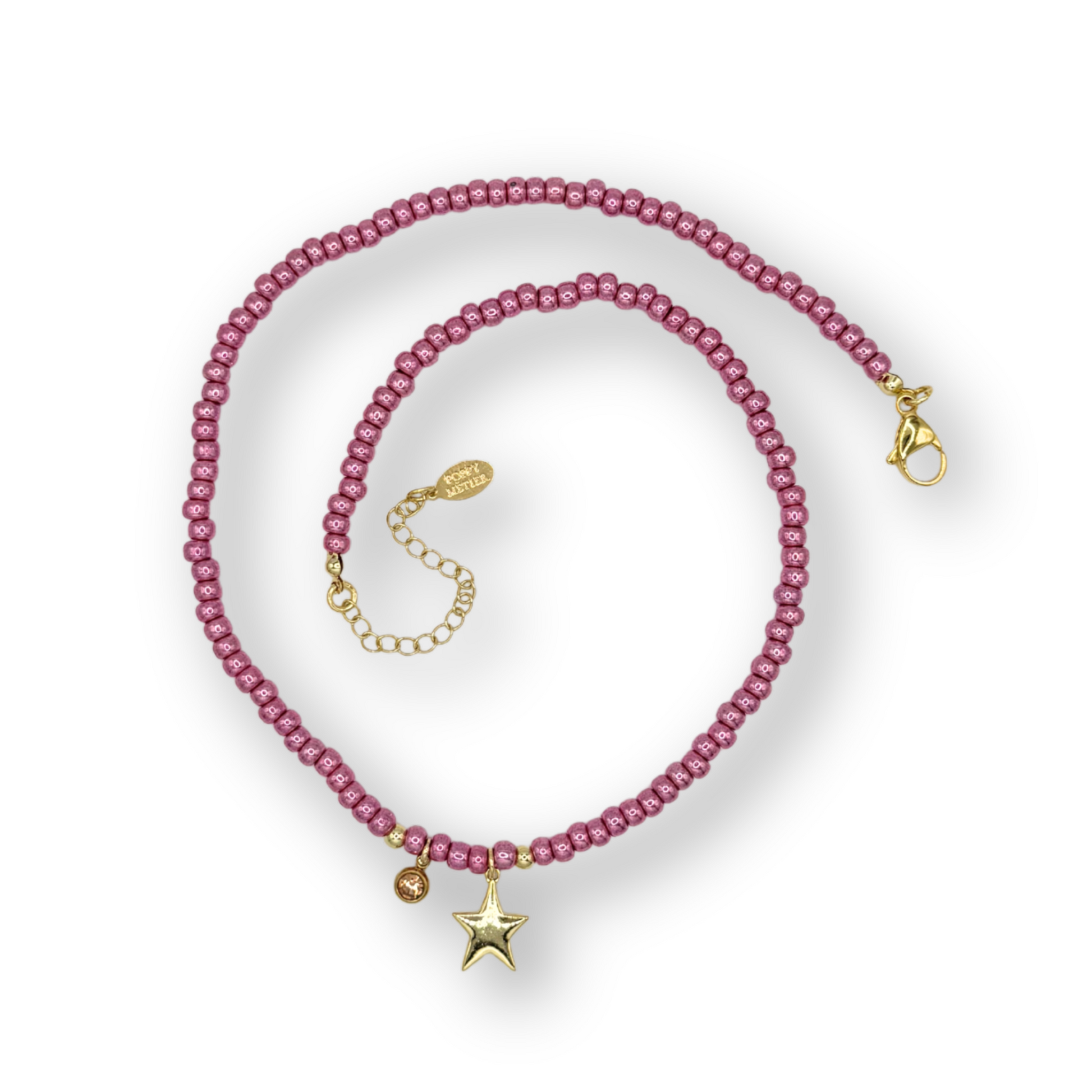 Pink beaded bracelet with gold accents on a white background