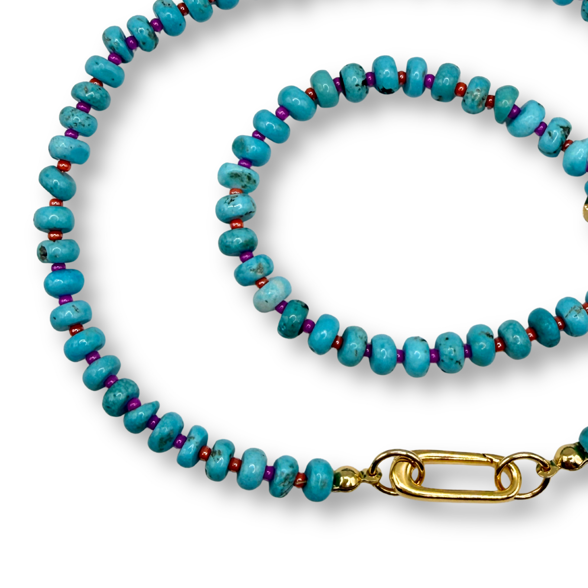 A beaded necklace and matching bracelet featuring turquoise-blue round beads separated by small purple beads, with a gold-tone lobster clasp on the necklace, displayed on a white background.