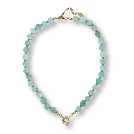 Turquoise beaded necklace with gold clasp on a white background