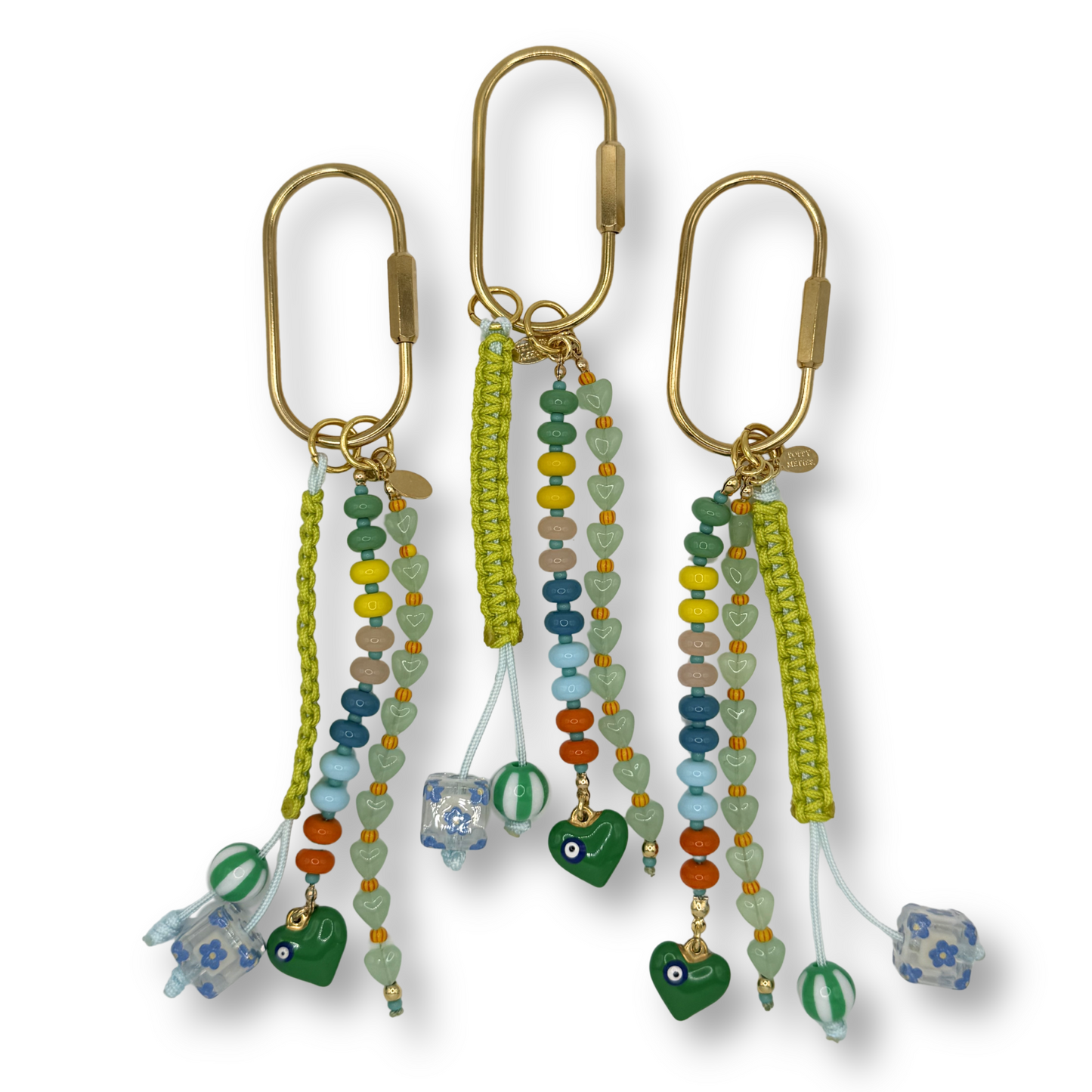 Set of beaded keychains with various charms on a white background