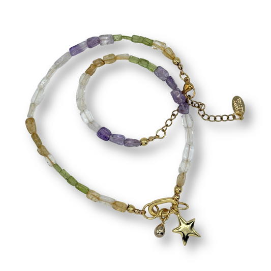 Multicolored beaded bracelet with star charm on a white background