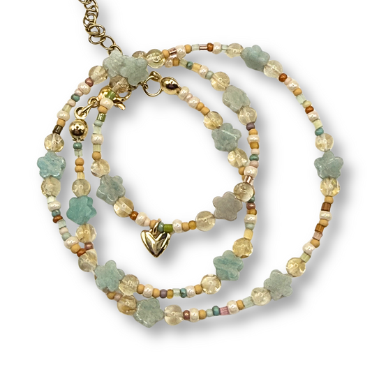Set of beaded necklaces with a heart pendant on a white background