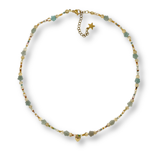 Necklace with green beads and gold chain on a white background